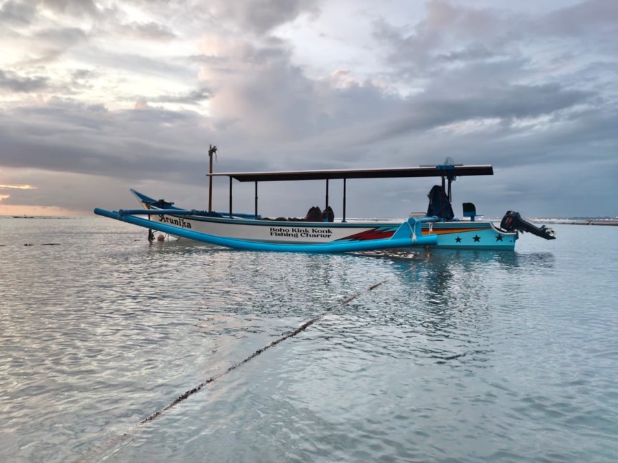 Arunika — our outrigger fishing boat, side view at dawn