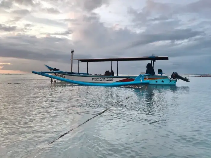 Arunika — our outrigger fishing boat, side view at dawn