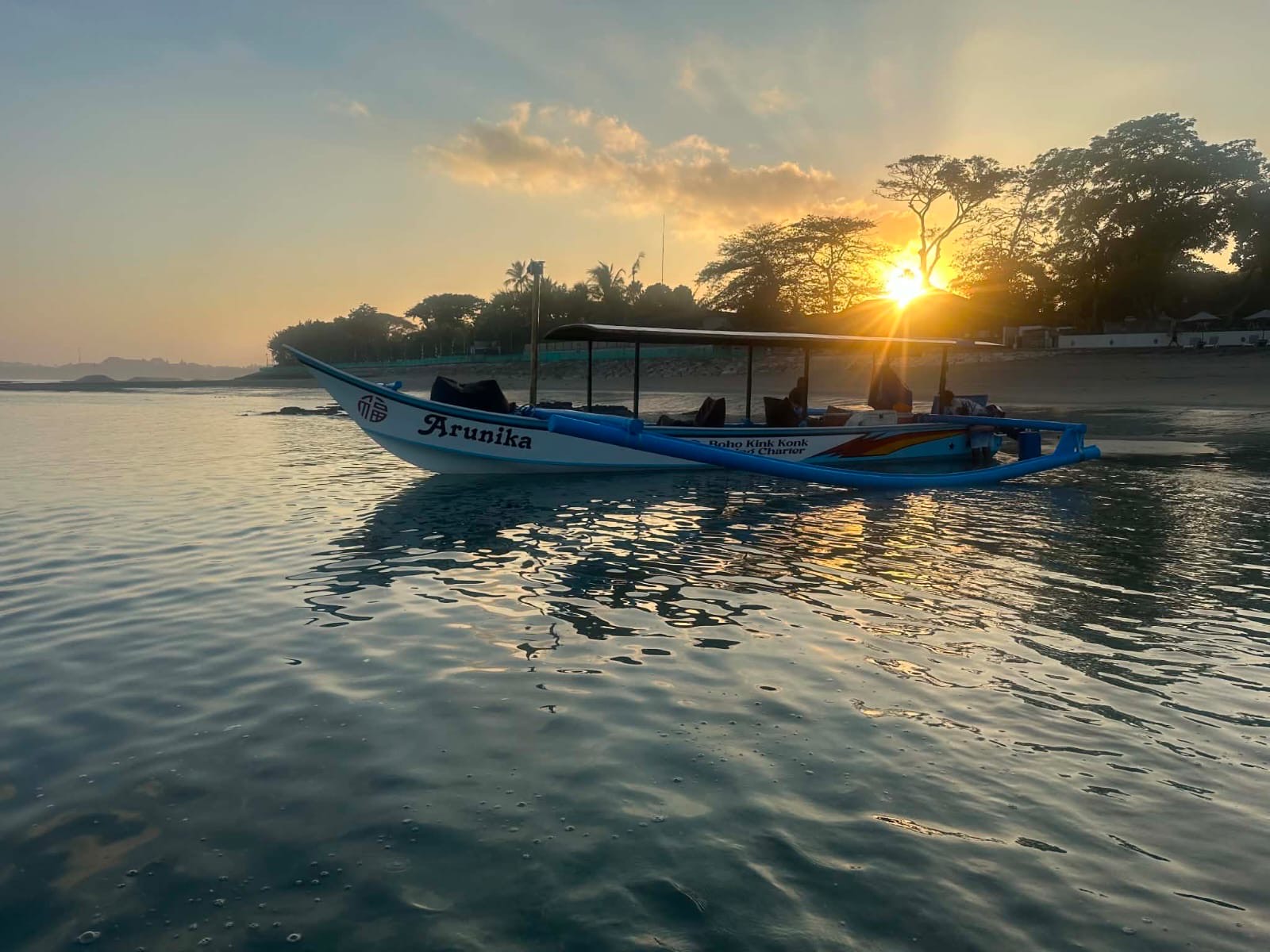 Arunika, the Boho Kink Konk outrigger, at sunrise off Kuta beach, Bali