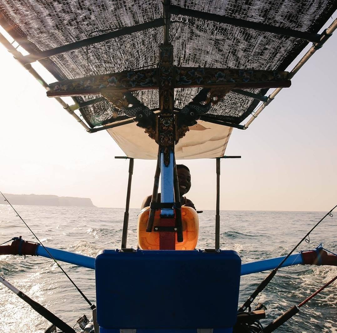 Traditional outrigger fishing boat at sea off Kuta, Bali